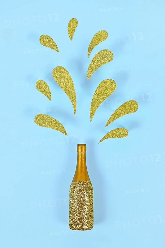 Golden splashing Champagne bottle on blue background