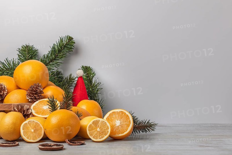 Basket with oranges and lemons, vitamin C, Christmassy, light background, copy room