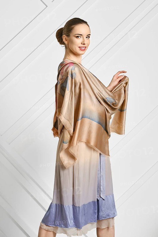 Cheerful woman with silk scarf posing in profile