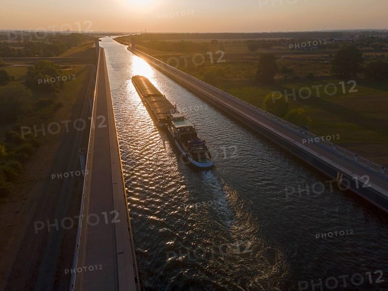 Drone shot, cargo ship in the sunset on the Mittelland Canal, Magdeburg waterway junction, canal bridge, Mittelland Canal, Elbe, Magdeburg, Saxony-Anhalt, Germany, Europe