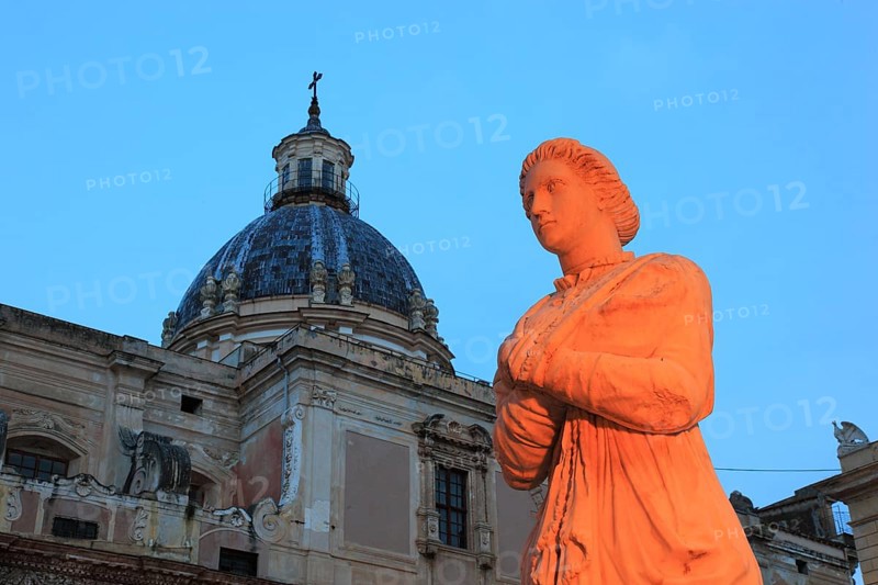In the old town of Palermo, in Piazza P, Sicily, Italy Retoria, fountain figure of the Fontana Pretoria and the dome of the Church of Santa Caterina