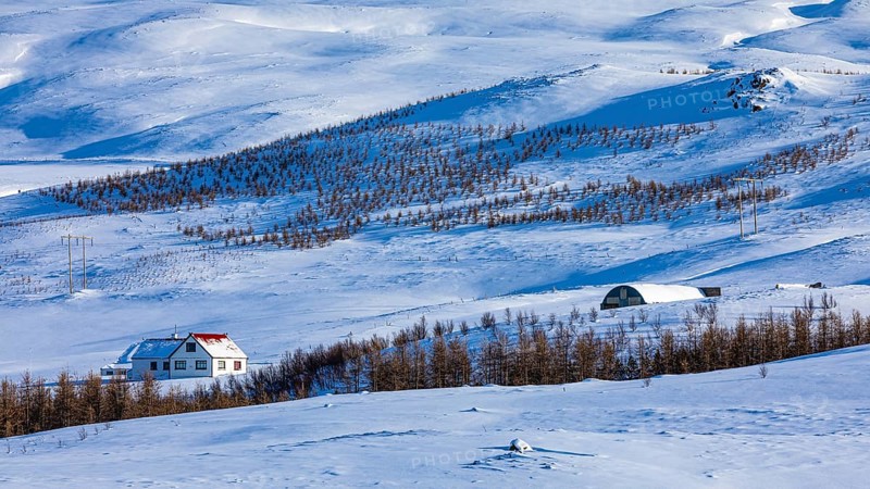 Farmhouse in snow-covered hilly landscape, near Akureyri, North Iceland Eyestra, Iceland, Europe