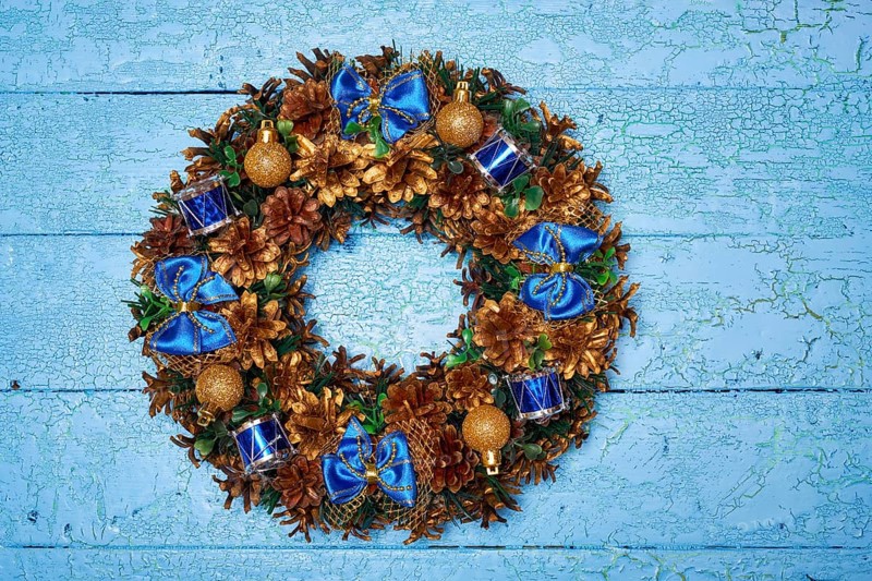 Christmas wreath on blue painted wooden background