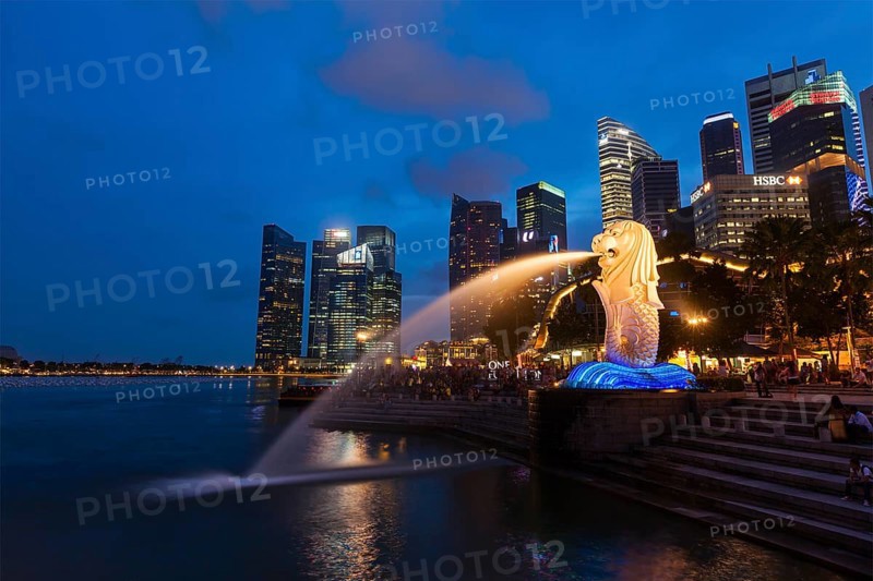 SINGAPORE, JANUARY 1, 2014: Night view of Singapore Merlion at Marina Bay against Singapore skyline. Merlion is a well-known tourist icon, mascot and national personification of Singapore