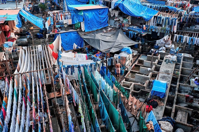 MUMBAI, INDIA, OCTOBER 31, 2019: Dhobi Ghat (Mahalaxmi Dhobi Ghat) is open air laundromat lavoir in Mumbai, India with laundry drying on ropes. Now signature landmark tourist attractions of Mumbai