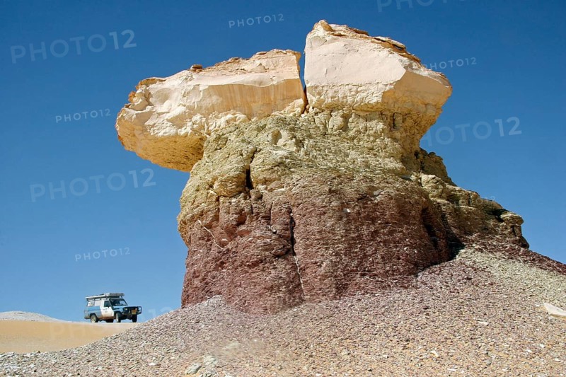 Four-wheel drive vehicle and limestone rock formation in Egypt's White Desert, Sahara el Beyda near Farafra in the Western Desert, North Africa