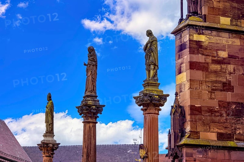 Plague pillars with patron saints in front of the main portal of Freiburg Cathedral on Münsterplatz in the historic old town of Freiburg im Breisgau, Baden-Württemberg, Germany, Europe