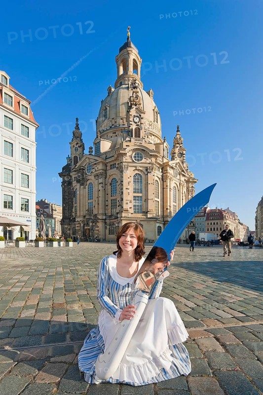 Stollen girl Lisa Straßberger presents the giant stollen knife in front of the Church of Our Lady