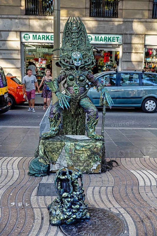 Street performer, mime, living statue of an alien, fantasy figure on the roadside, city centre, Barcelona, Spain, Europe