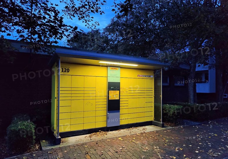 DHL Packstation at dusk in front of housing estate, Norderney Island, East Frisia, North Sea, Lower Saxony, Germany, Europe