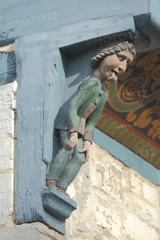 Wood carving with figure on the historic half-timbered house Bracken, tongue, sticking out, grimace, market place, Bad Gandersheim, Lower Saxony, Germany, Europe
