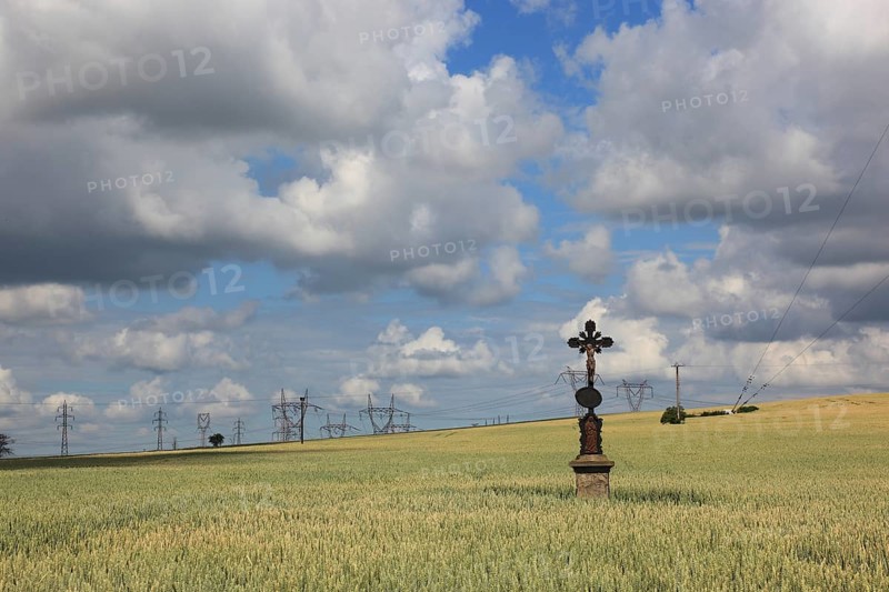 Field cross in a wheat field, in the background power lines, near Dukovany, Czech Republic, Grain field with a lonely field cross, near Dukovany, South Moravia, Kraj Vysocina, Czech Republic, Europe