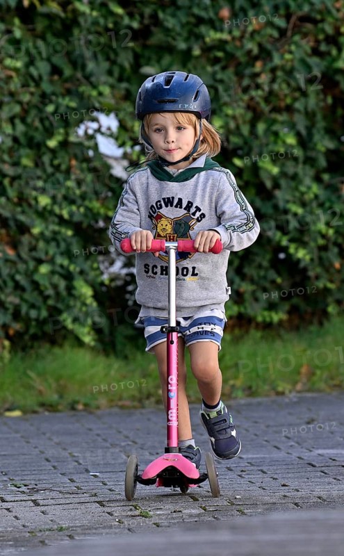Boy with helmet, blond, 5 years, riding scooter, pink. Stuttgart, Baden-Württemberg, Germany, Europe