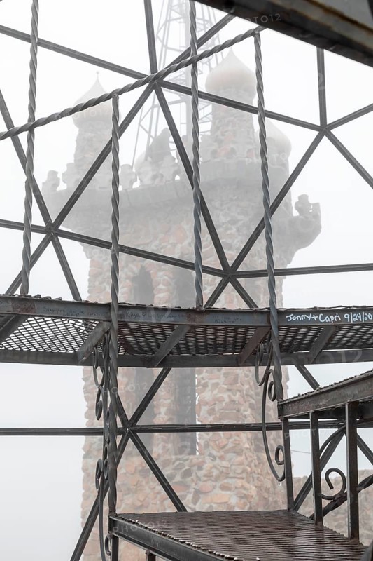 Rye, Colorado, Towers of Bishop Castle on a foggy morning. The Castle is an elaborate stone and metal structure and roadside attraction. It is being built by Jim Bishop in the mountains of San Isabel National Forest