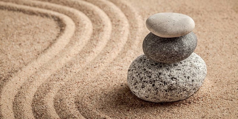 Japanese Zen stone garden, relaxation, meditation, simplicity and balance concept, letterbox panorama of pebbles and raked sand tranquil calm scene