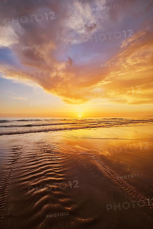 Atlantic ocean sunset with surging waves at Fonte da Telha beach, Costa da Caparica, Portugal, Europe