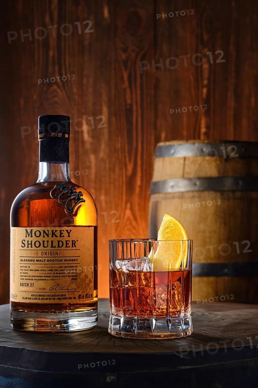 April 8, 2022, Minsk, Belarus, bottle and glass with Monkey Shoulder blended malt scotch whisky with a barrel on background, Europe