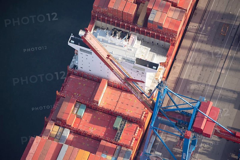 Container ship of the shipping company Hamburg Süd the Santa Aerial view of the container ship of the shipping company Hamburg Süd the Santa Teresa at Terminal Burchardkai, Hamburg, Germany at Terminal Burchardkai