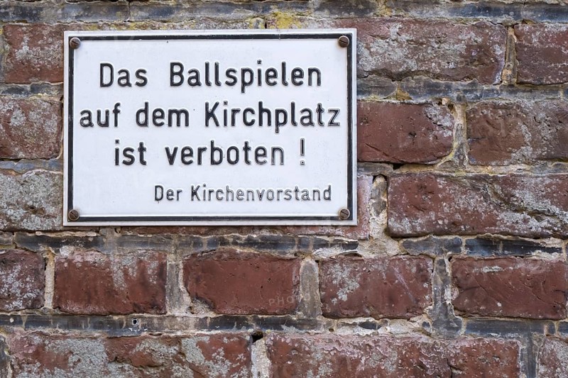 Sign with inscription Playing ball on the church square is forbidden! The church council, Münsterland, North Rhine-Westphalia, Germany, Europe
