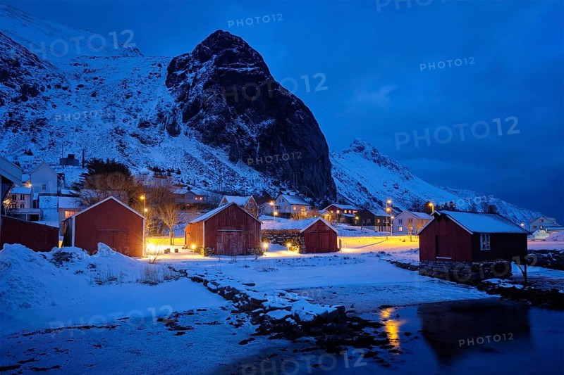 Ramberg village with red traditional rorbue houses in the night. Ramberg, Flakstad, Nordland, Norway, Europe