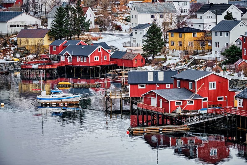 Reine fishing village on Lofoten islands with red rorbu houses in winter with snow. Lofoten islands, Norway, Europe