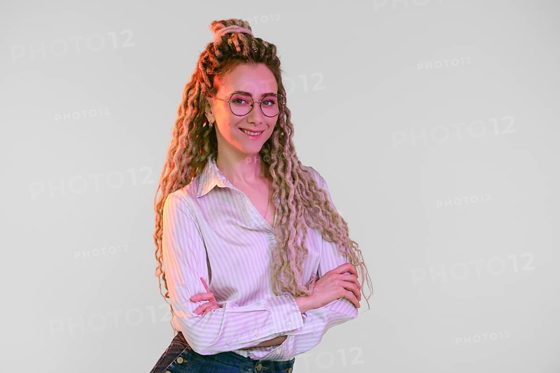 Young woman with dreadlocks crossed hands on chest