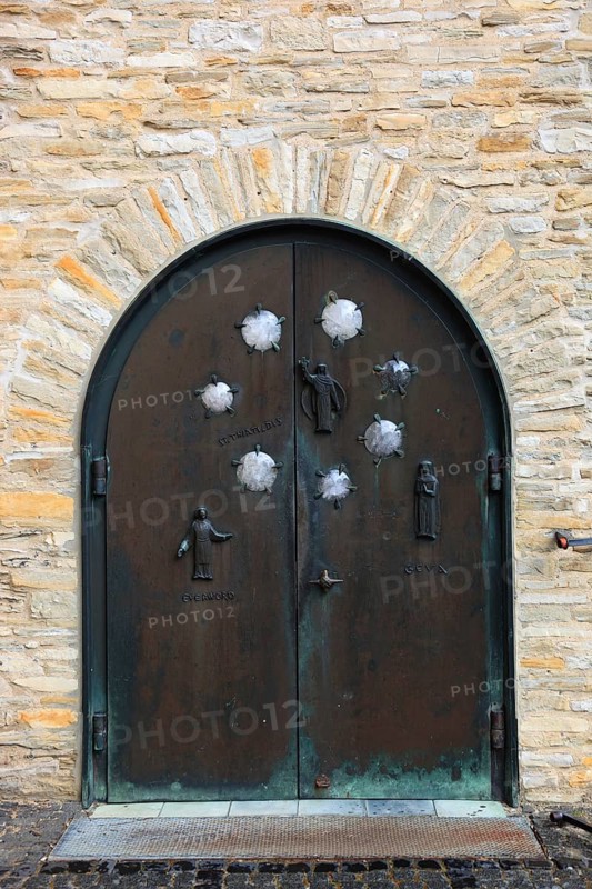 Entrance gate on the south side shows the founders of the monastery, the nobleman Everword and his woman Geva, as well as the niece Thiatildis, St. Boniface, a former free-world ladies' monastery with a collegiate church in Freckenhorst, Warendorf district, North Rhine-Westphalia, Germany, Europe