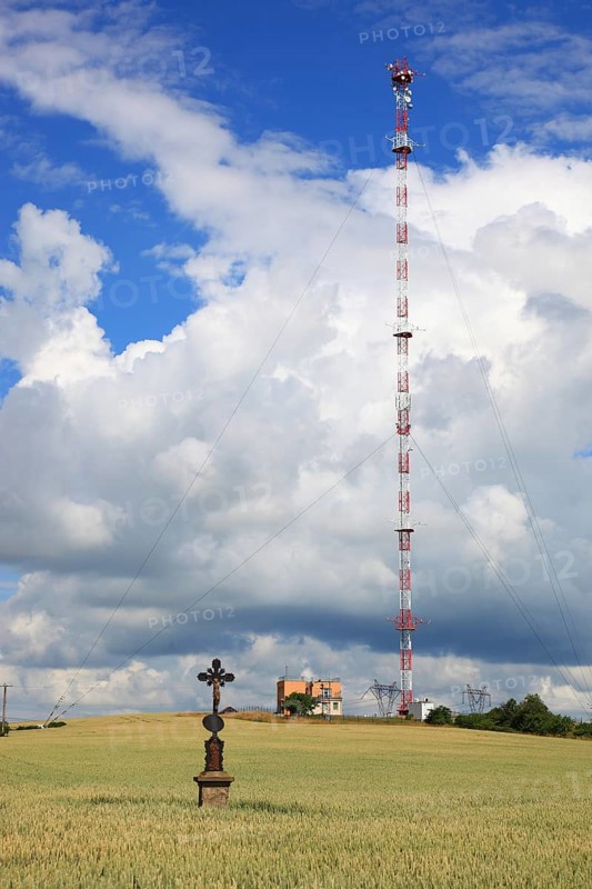 Wheat field, grain field with a lonely field cross, in the background transmitting station with high radio mast, near Dukovany, South Moravia, Kraj Vysocina, Czech Republic, Europe
