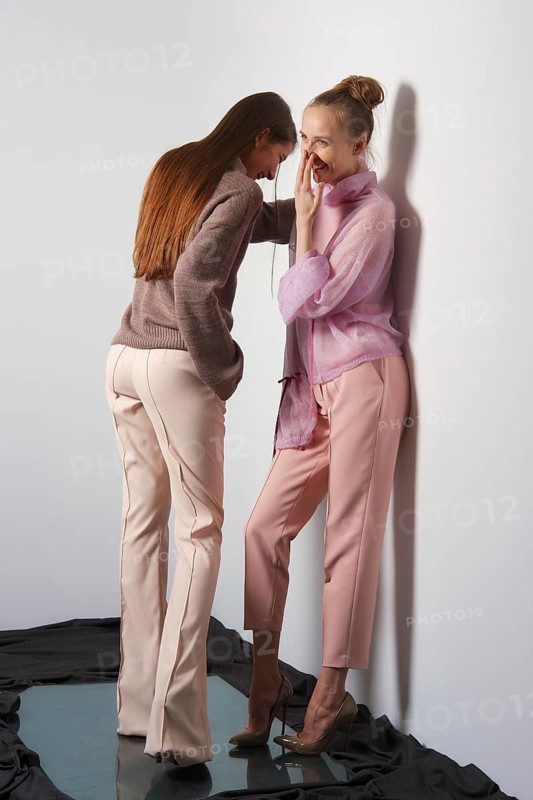 Two pretty girls laughing and gossip