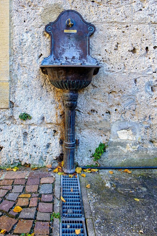 Public water supply, tap with drinking water connection and drainage basin at the town museum Klostermühle, Bad Urach, Swabian Alb, Baden-Württemberg, Germany, Europe