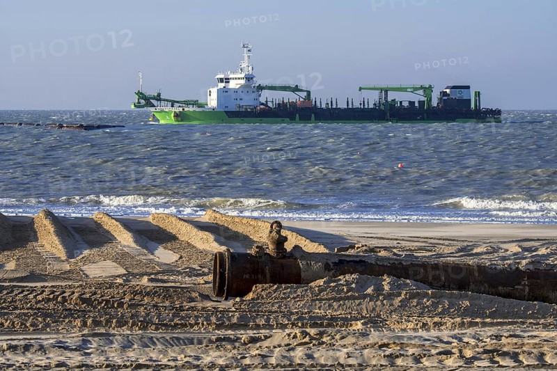DEME trailing suction hopper dredger Uilenspiegel at sea, used for sand replenishment, beach nourishment to make wider beaches to reduce storm damage