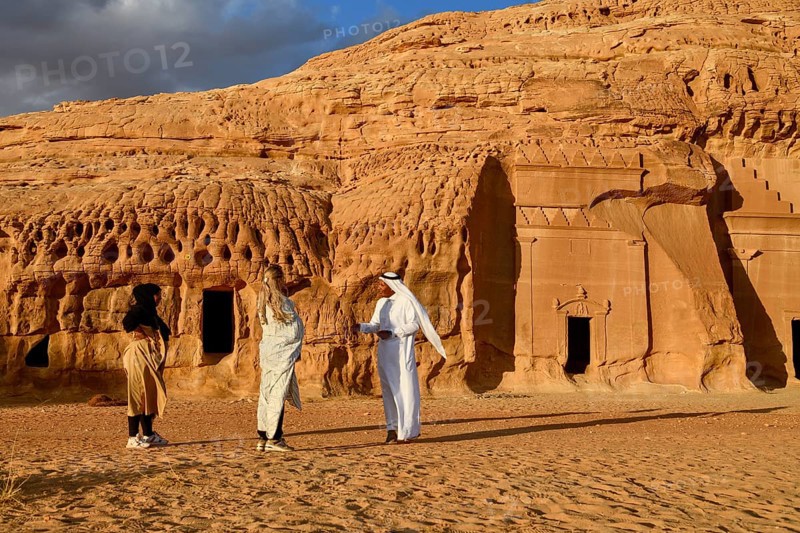Tourists in front of the Nabataean tombs at the rock Qasr Al-Bint, Hegra or Mada'in Salih, AlUla region, Medina province, Saudi Arabia, Arabian Peninsula, Asia