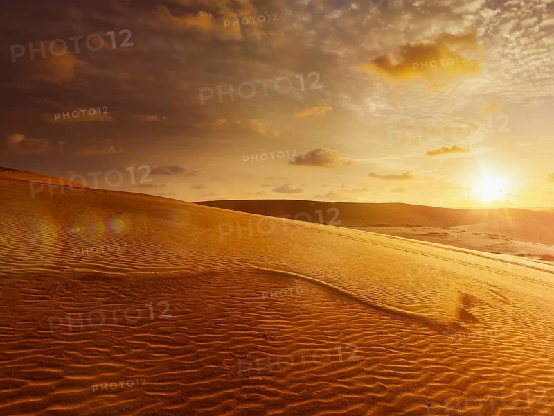 White sand dunes on sunrise, Mui Ne, Vietnam. With lens flare and light leak