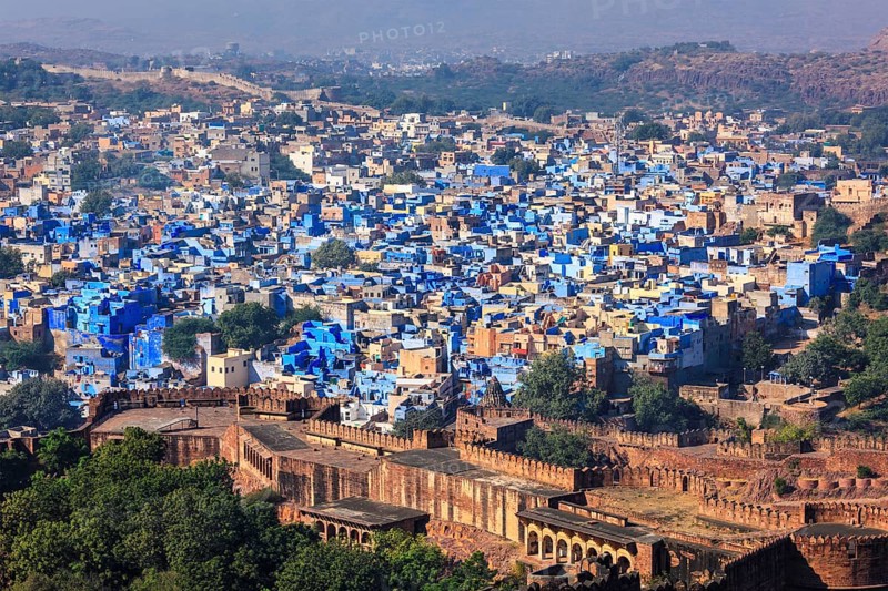 Aerial view of Jodhpur, also known as Blue City due to the vivid blue-painted Brahmin. View from Mehrangarh Fort (part of fortifications is also visible) . Jodphur, Rajasthan, India, Asia