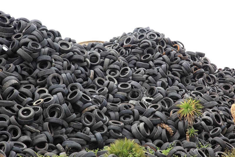 Old car tyres lie on stockpiles for recycling