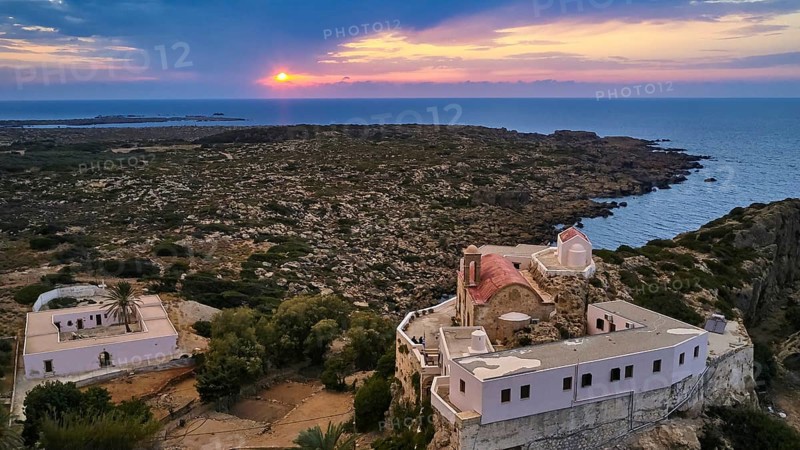 Drone shot, dusk, sunset, cloudy sky, square yard, sea, Chrissoskalitissa, rock monastery, Orthodox monastery, southwest tip, Chania province, Crete, Greece, Europe