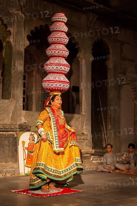 UDAIPUR, INDIA, NOVEMBER 24: Bhavai performance, famous folk dance of Rajasthan state. Performer balances number of pots as she dances on broken glass. November 24, 2012 in Udaipur, Rajasthan, India, Asia