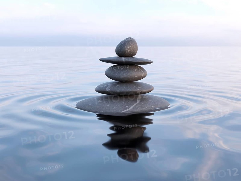 Zen stones in water with reflection, peace balance meditation relaxation concept