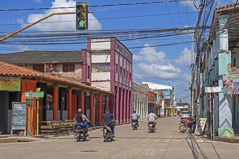 Streetscene showing Bolivians on motorcycles in the colonial city centre of Trinidad in the Amazon, Cercado Province, Beni Department, Bolivia, South America