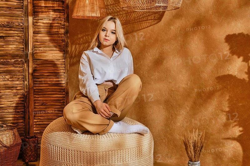 Teenager girl sit on a padded stool in relaxing environment
