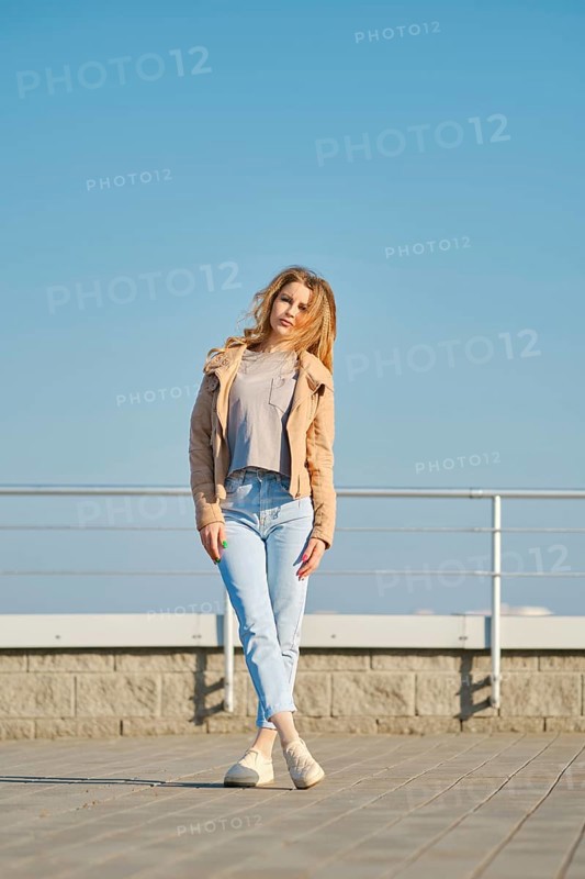 Young woman in casual clothes posing on the street