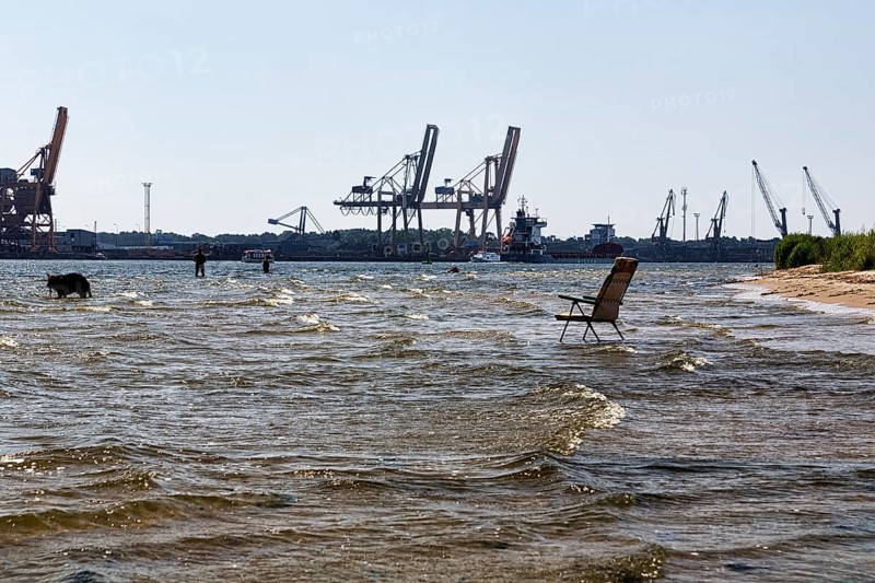 Garden chair in the water, symbol photo cooling off in summer, harbour entrance port city Swinoujscie, Swinoujscie, river Swina, West Pomerania, Poland, Europe