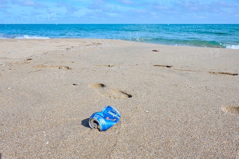 Old can, rubish lying on the sand on a beach, near Tarragona, Catalonia, Spain, Europe