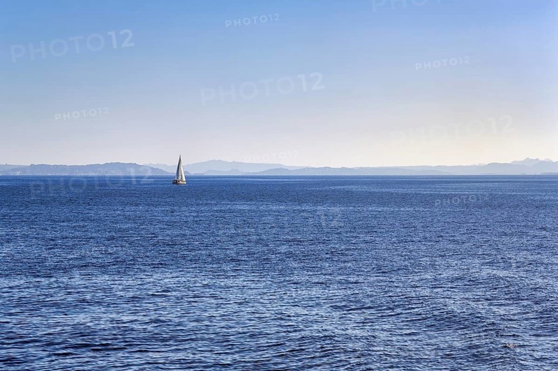 Strait, Strait of Bonifacio, sailboat in front of Sardinia Island on horizon, blue sky, Mediterranean Sea, Bonifacio, Corsica, France, Europe