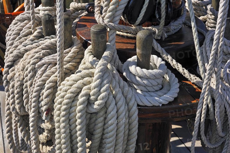 Ropes coiled around belaying pins aboard the Grand Turk, Etoile du Roy, a three-masted sixth-rate frigate replica of HMS Blandford, built in 1741 and based in Saint Malo, Brittany, France, Europe