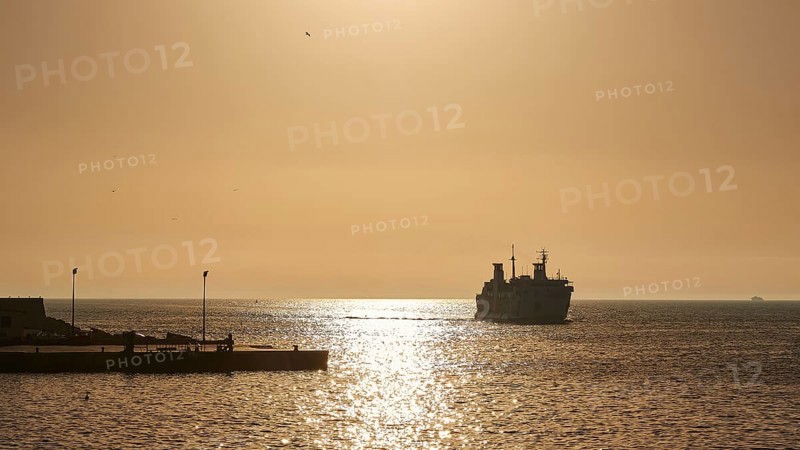 Morning light, backlight, ferry, silhouette, Levanzo town, main town, Levanzo, Egadi Islands, Sicily, Italy, Europe
