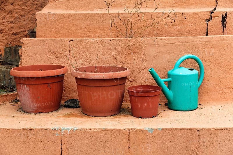 Empty flower pots with watering can on a wall, terrace, lost place, Spain, Europe