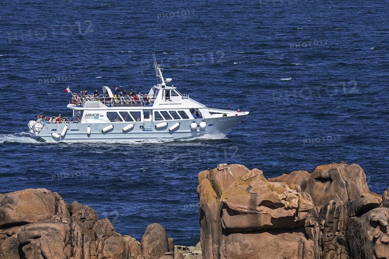 Excursion boat Armor Navigation sailing with tourist along Côte de granit rose, Pink Granite Coast to the Sept-Iles islands, Côtes-d'Armor, France, Europe