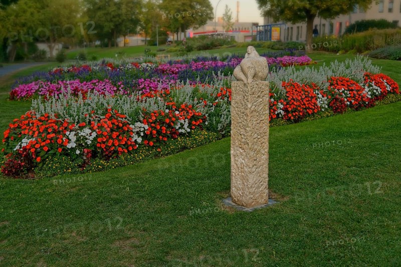 The sculpture Venus of Amberg surrounded by a colourful flower bed in the municipal park, Amberg, Upper Palatinate, Bavaria, Germany, Europe