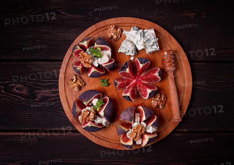 Appetizer, Figs with blue cheese, walnut, honey, on a wooden board, top view, close-up, no people